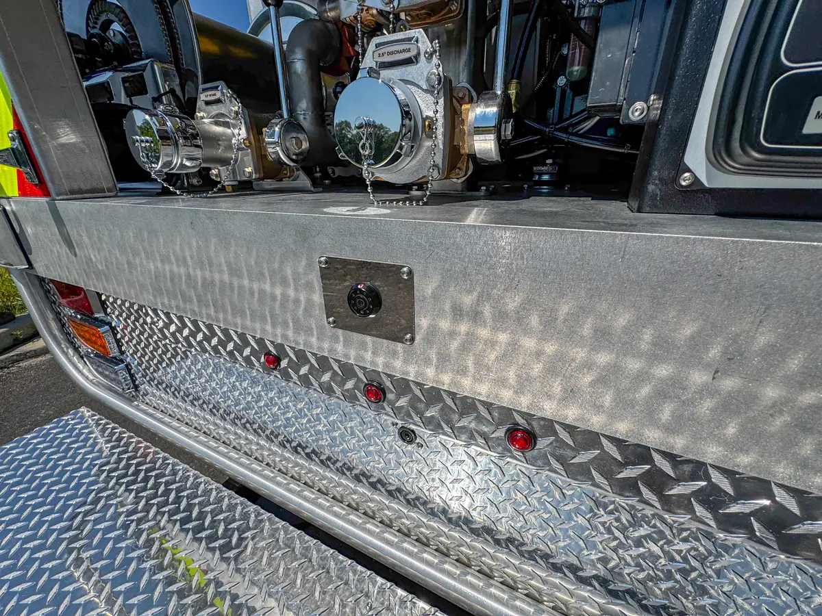 Rear bumper and tailboard view with chevron panel and step platform.